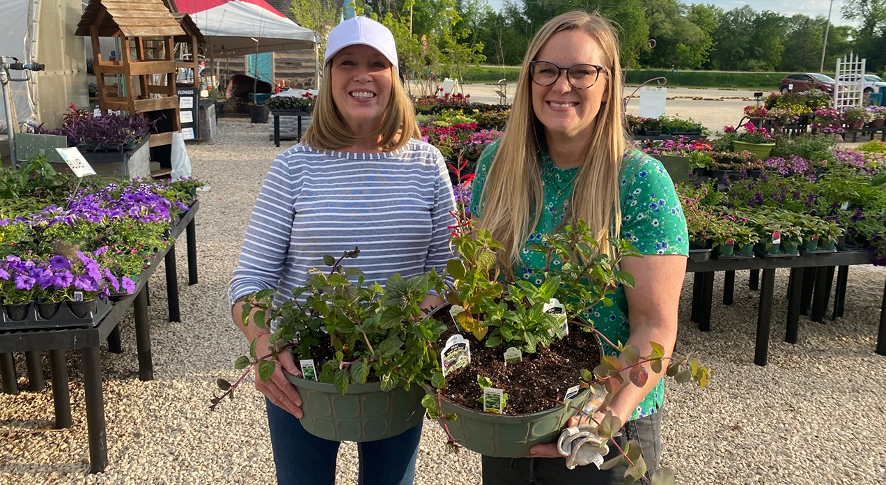 Two people with herb planters.